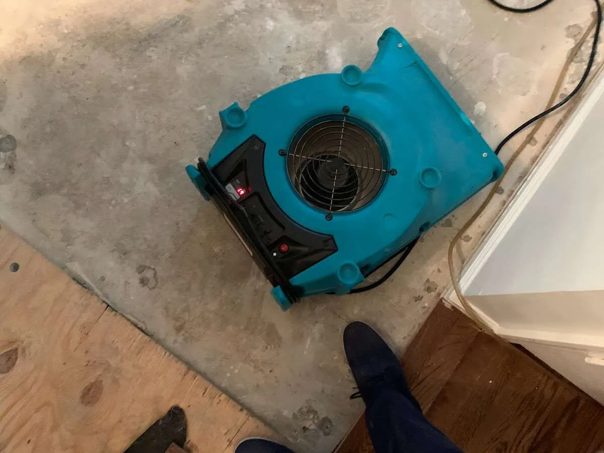 Air mover drying subfloor during Commercial Water Damage Restoration in Lake of the Woods